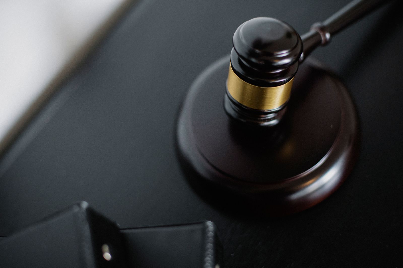 Wooden judge's gavel on a courtroom table representing the Baltimore prediction-market lawsuit against Kalshi and Polymarket