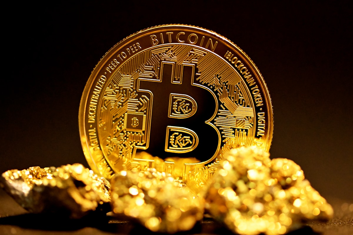 Bitcoin coin surrounded by gold pieces representing first cryptocurrency purchase