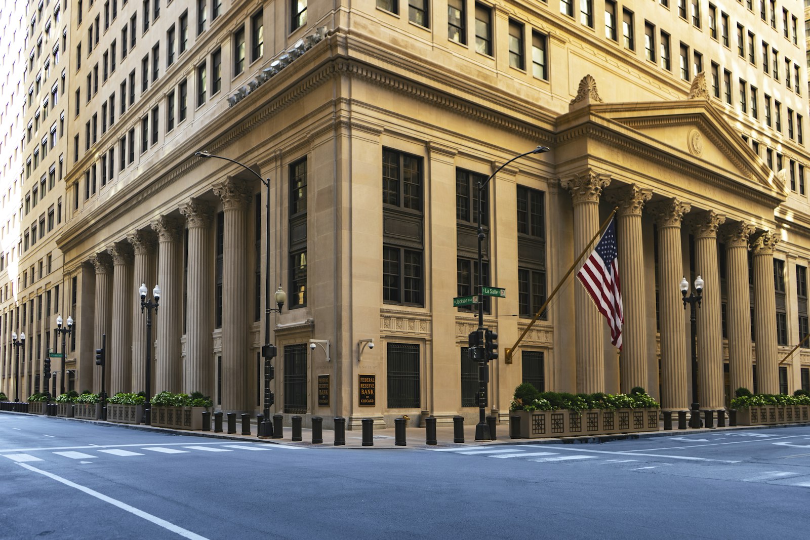 A large neoclassical government building with columns and an American flag, representing the OCC national bank charter decision for World Liberty Financial and its USD1 stablecoin