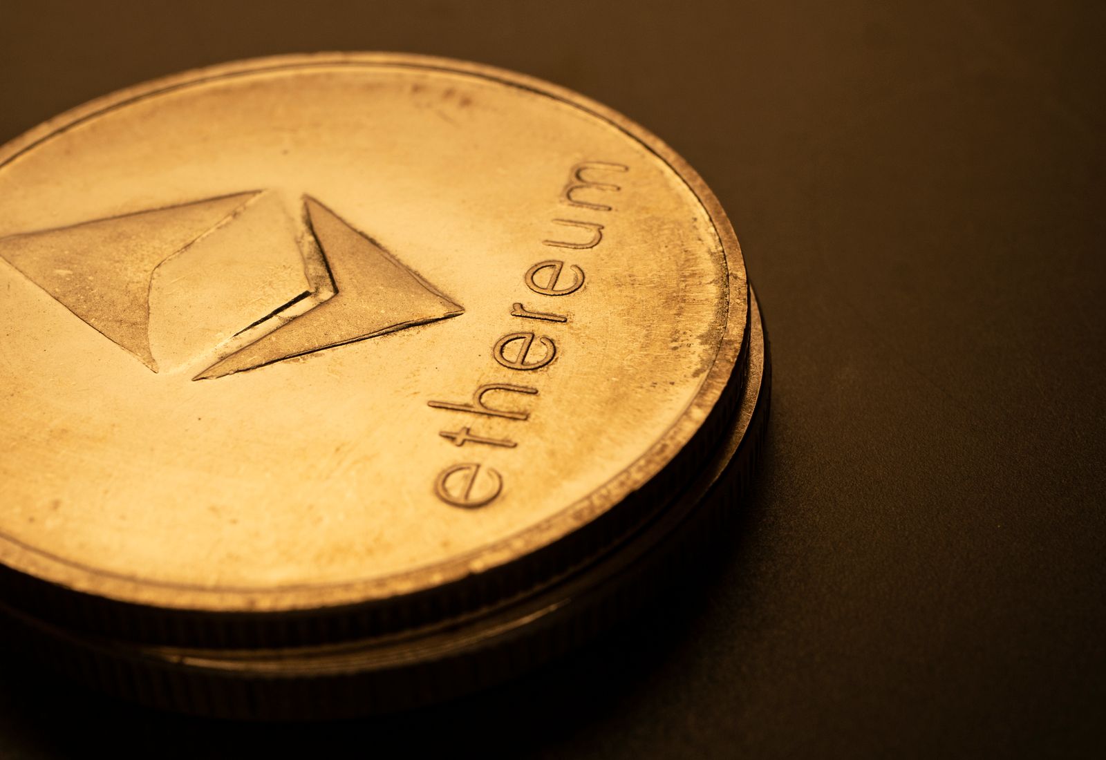 Dark macro photograph of an Ethereum logo coin
